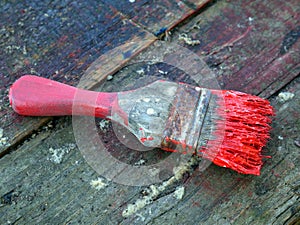 Old brushes in the paint process of painting an old board