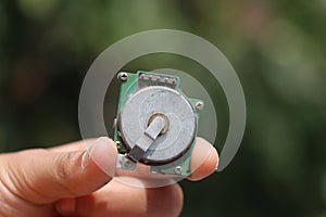 Old brushless dc motor held in the hand. Dc motor found in small electronic devices like printers