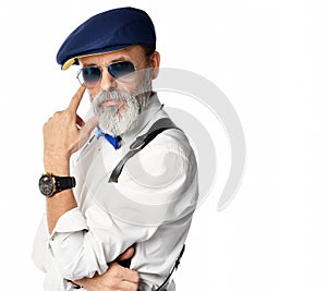 Old brutal senior millionaire man in white shirt and aviator sunglasses looks judging stylish fashionable men photo