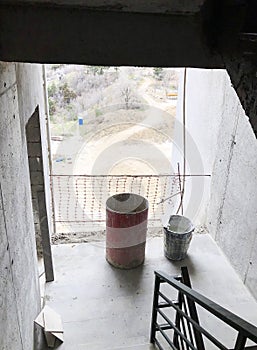 Old bucket with dirty water. Material for repairs in an apartment is under construction remodeling rebuilding and renovation