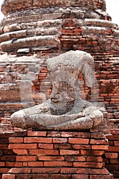 Old Buddha statue without head in the midst of ruins of the Chaiwatthanaram Temple Ayutthaya, Thailand