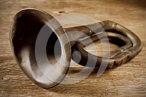 Old bugle on a wooden surface