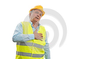 Old builder touching heart