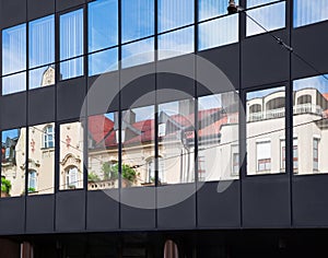 Old building architecture reflected in modern building