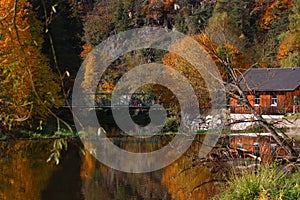 Old building and bridge at the coasts of a lake on a beautiful autumn day