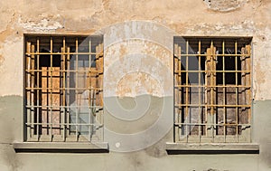 Old building with broken glass windows and rusty bars