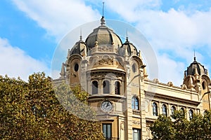 Old building with clock and triple dome, Barcelona, Spain