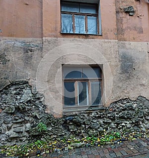 Old building with damaged restoration wall
