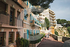 Old building facade, turquoise wooden blinds, urban view, Monaco