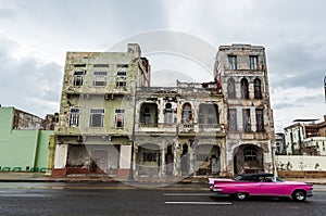 HAVANA, CUBA - OCTOBER 21, 2017: Old Building in Havana, Unique Cuba Architecture. Moving car in foreground