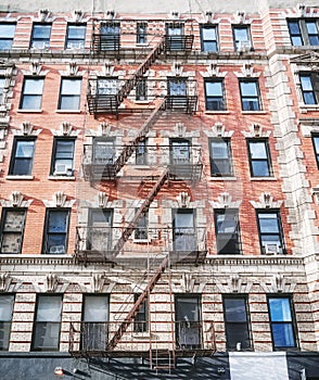 Old building with iron fire escape in New York City, USA