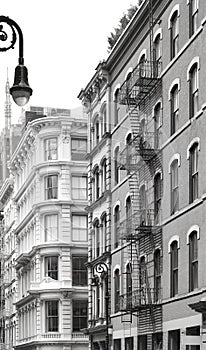 Old building with iron fire escapes, black and white picture of New York cityscape, USA