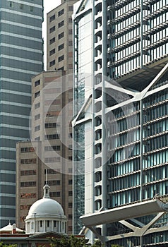 Old building among modern skyscrapers