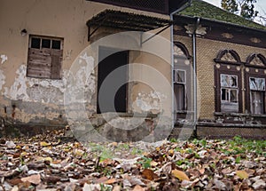 Old building in park at the fall time, rustic and falling apart from elapsed time