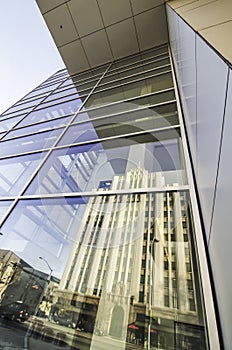 Old building reflected modern building windows