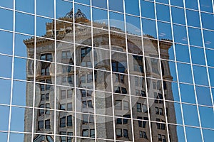 Old building reflection in glass skyscraper