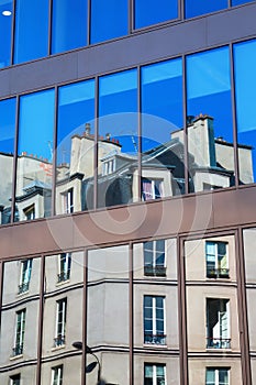 Old building reflects in windows in Paris