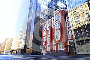 Old building stands next to two new buildings