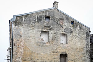 Old Building Wall with Exposed Brick and Empty Windows