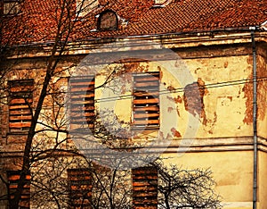 Old building with wooden plank boarded up windows