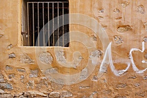 Old Building Yellow Stone Wall With Window And Rusty Bars