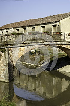 Old buildings along a canal near Badia Polesine photo