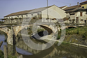 Old buildings along a canal near Badia Polesine photo