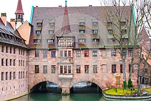 Old buildings and arch bridge reflected in water. Nuremberg, Bavaria