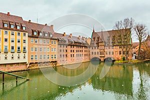 Old buildings and arch bridge reflected in water. Nuremberg, Bavaria