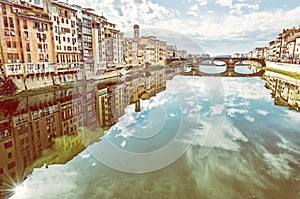 Old buildings and beautiful Ponte Santa Trinita, Arno, Florence, Italy, yellow filter