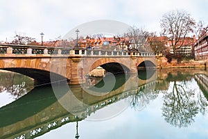 Old buildings and bridge reflected in water. Nuremberg, Bavaria