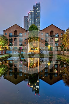 Old buildings and modern skyscrapers at night