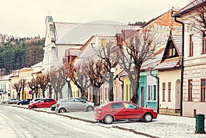 Old buildings and parked cars in street, Kezmarok, Slovakia