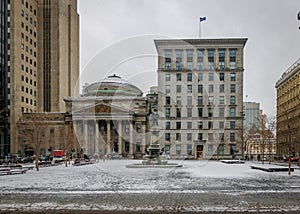 Old Buildings in Place d`Armes with snow - Montreal, Quebec, Canada photo