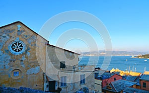 Old buildings and roofs with seascape in background in Portovenere  town. Lord Byron Park and Doria castle on Ligurian coast, La S