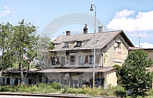 Old builing of railway station with cracked facade and vandal marks