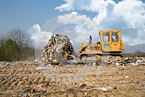 The old bulldozer moving garbage