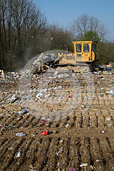The old bulldozer moving garbage