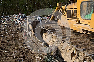 The old bulldozer moving garbage