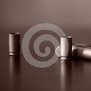 Old bullet cartridges on a dark background. Brown color toned