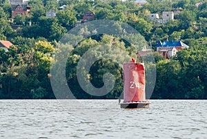 Old buoy on the river, red buoy,