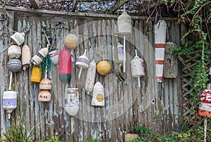 Old buoys on wooden fence