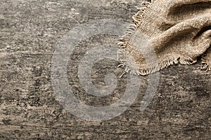 Old burlap fabric napkin, sackcloth on table background. top view with copy space