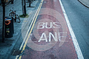 Old bus lane markings on tarmac in London