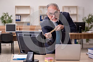Old businessman employee holding plunger at workplace