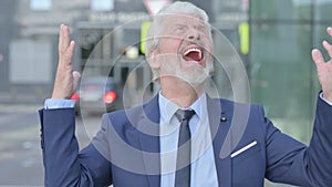 Old Businessman Screaming, Getting Crazy while Standing Outdoor