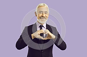 Old businessman show heart hand gesture