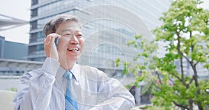 Old businessman speak phone