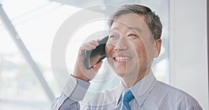 Old businessman speak phone