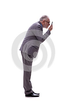Old businessman talking by phone isolated on white